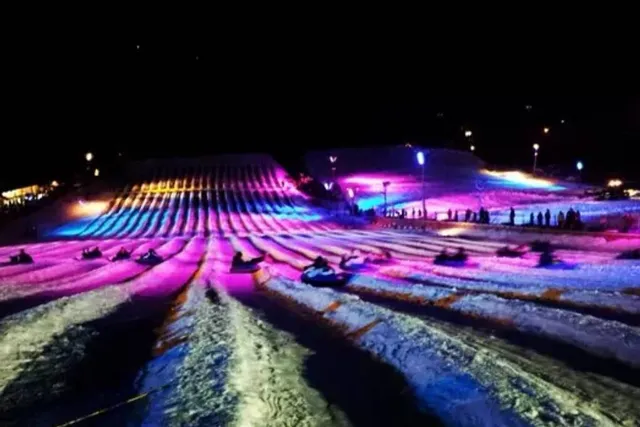 This ‘Galactic’ Winter Spot Near NYC Is The Number One Snow Tubing Destination In The U.S. — With 40 Tubing Lanes, Hot Tubs, Light Up Rainbow Slopes, And An Indoor Lazy River