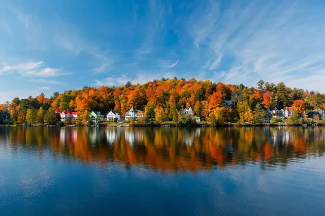 New York’s ‘Most Captivating’ Small Town Isn’t Lake Placid—It’s An Adirondack Gem With Glassy Lakes, A Thriving Art Scene, & A 125-Year-Old Ice Palace