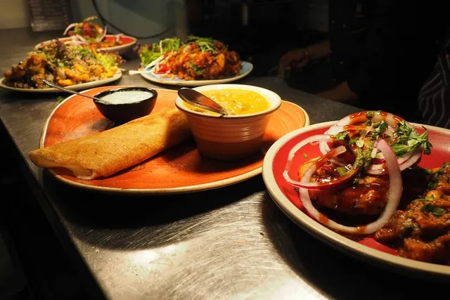 This Vibrant Micro-Neighborhood In Queens Is NYC’s ‘Little India’ — Home To Dosas, Masala Chai, & Indian Sweets