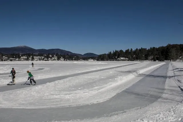 The Largest Natural Ice Skating Track In New York Is FREE And Tucked Into A Fairytale Olympic Village — With 2 Miles Of Winding Forest Views And Snowy Mountain Peaks On Top A Mirror-Like Frozen Lake