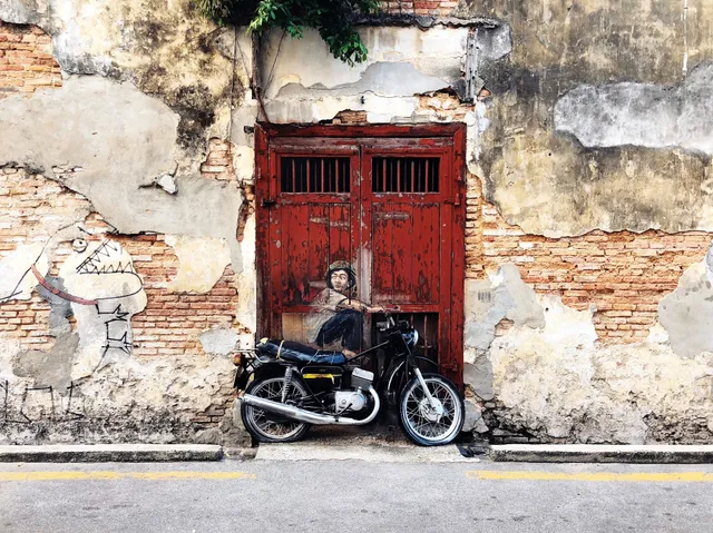 Penang Street Art - Boy on Motorbike by Ernest Zacharevic