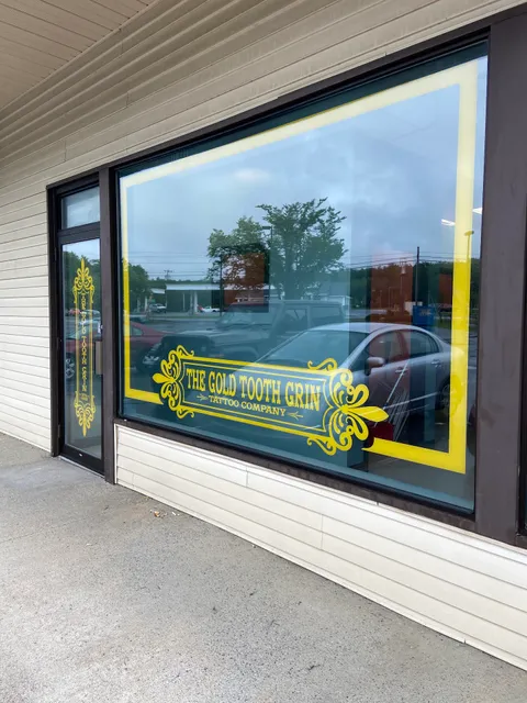 The Gold Tooth Grin Tattoo Company