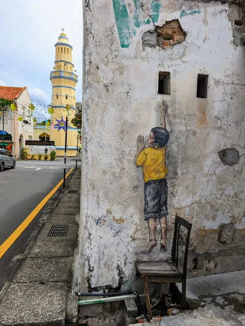 Penang Street Art - Boy on Chair by Ernest Zacharevic