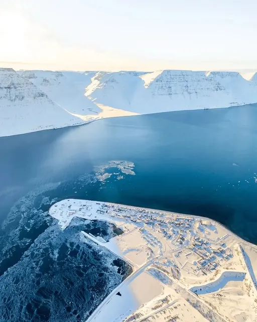 East Iceland · Red Cabin in a Snowy Seascape